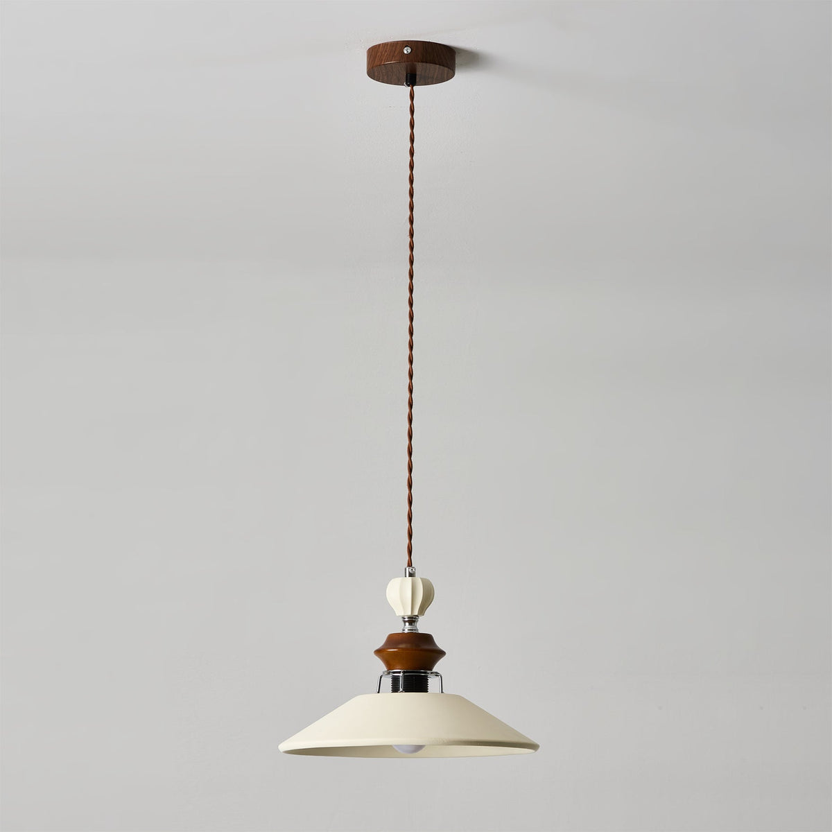 The pendant light against a dark wall to highlight its form.