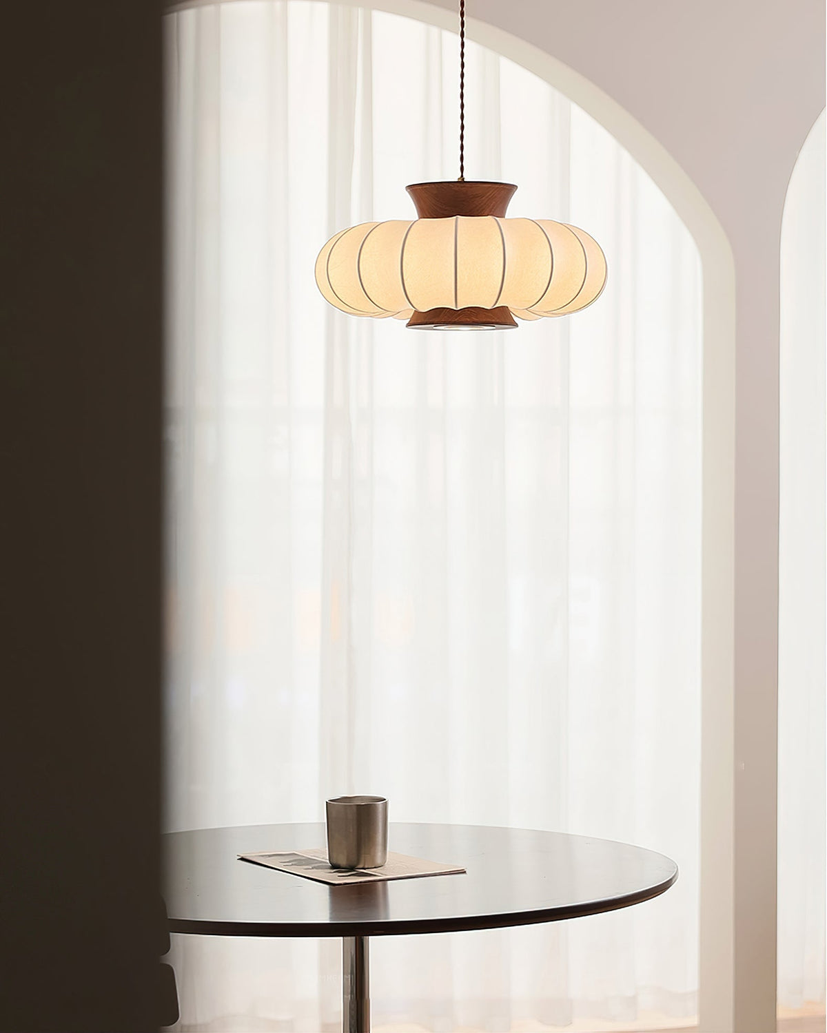 The smaller 40cm Aeron Pendant Light in a cozy reading nook.