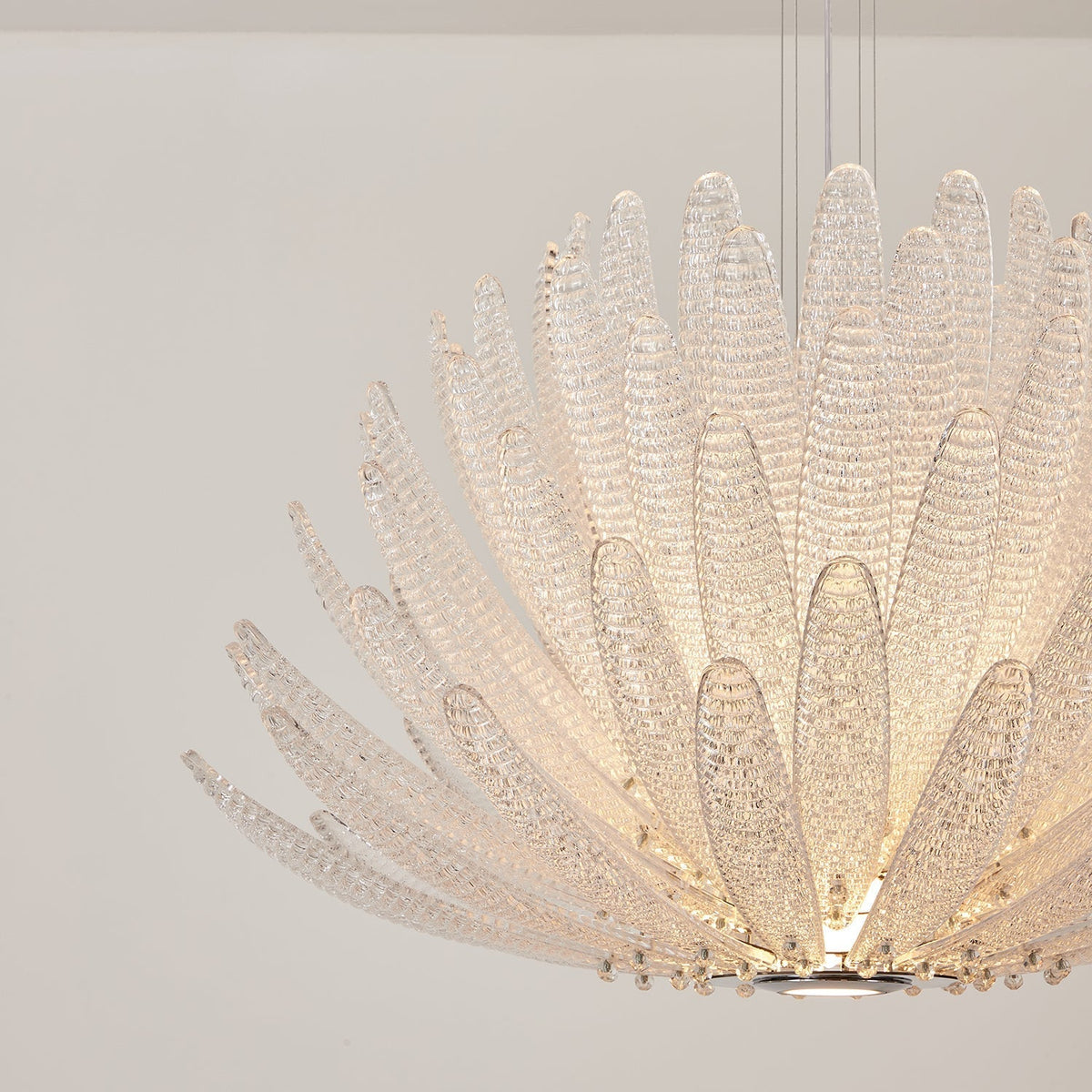 Detailed view of a single clear glass petal from the Agave Chandelier.