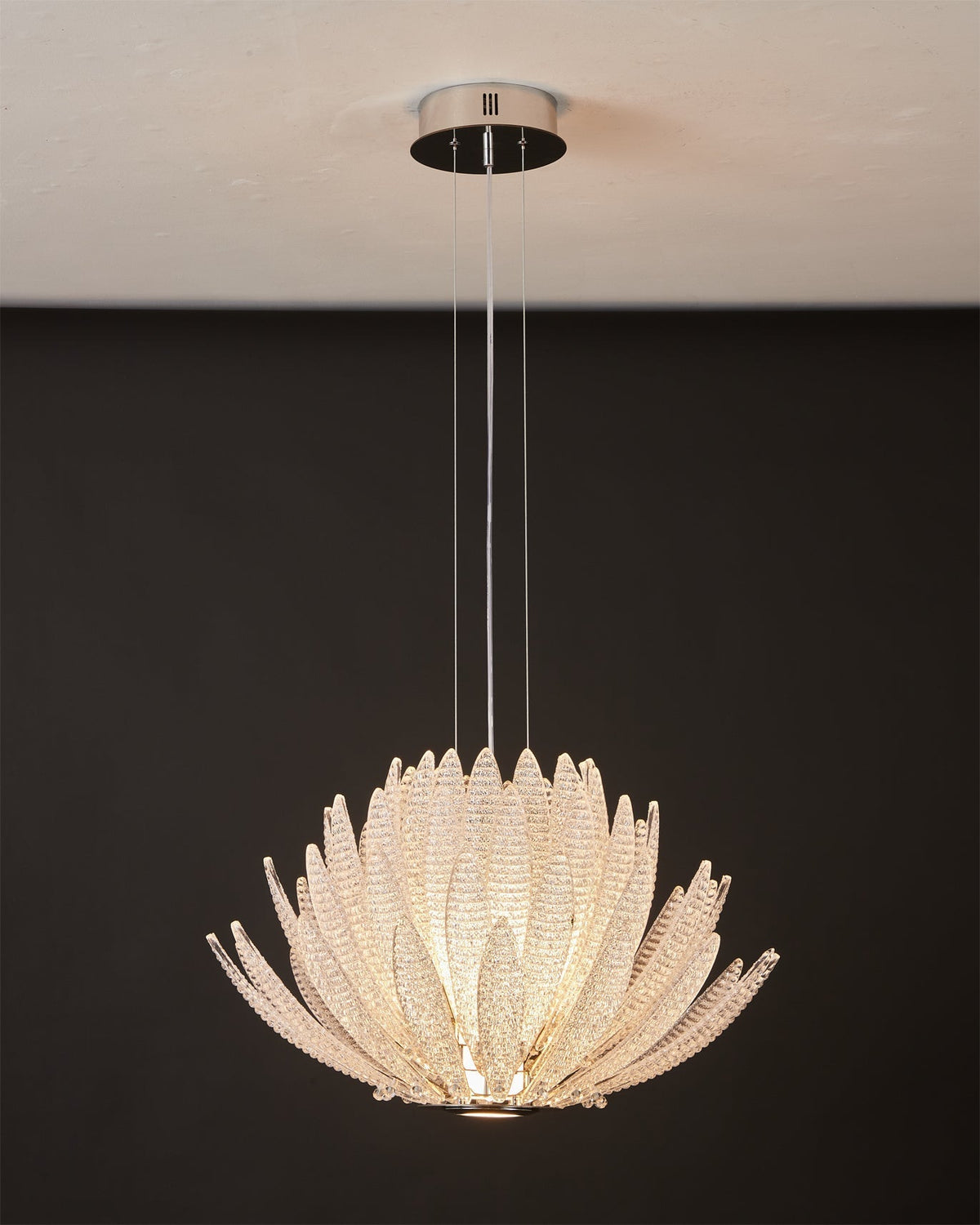 Agave Starburst Chandelier displayed in the warm amber glass color option.