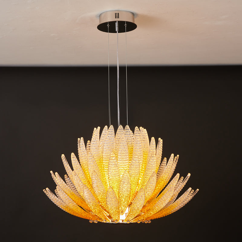 The amber glass Agave Chandelier creating a cozy ambiance in a bedroom.