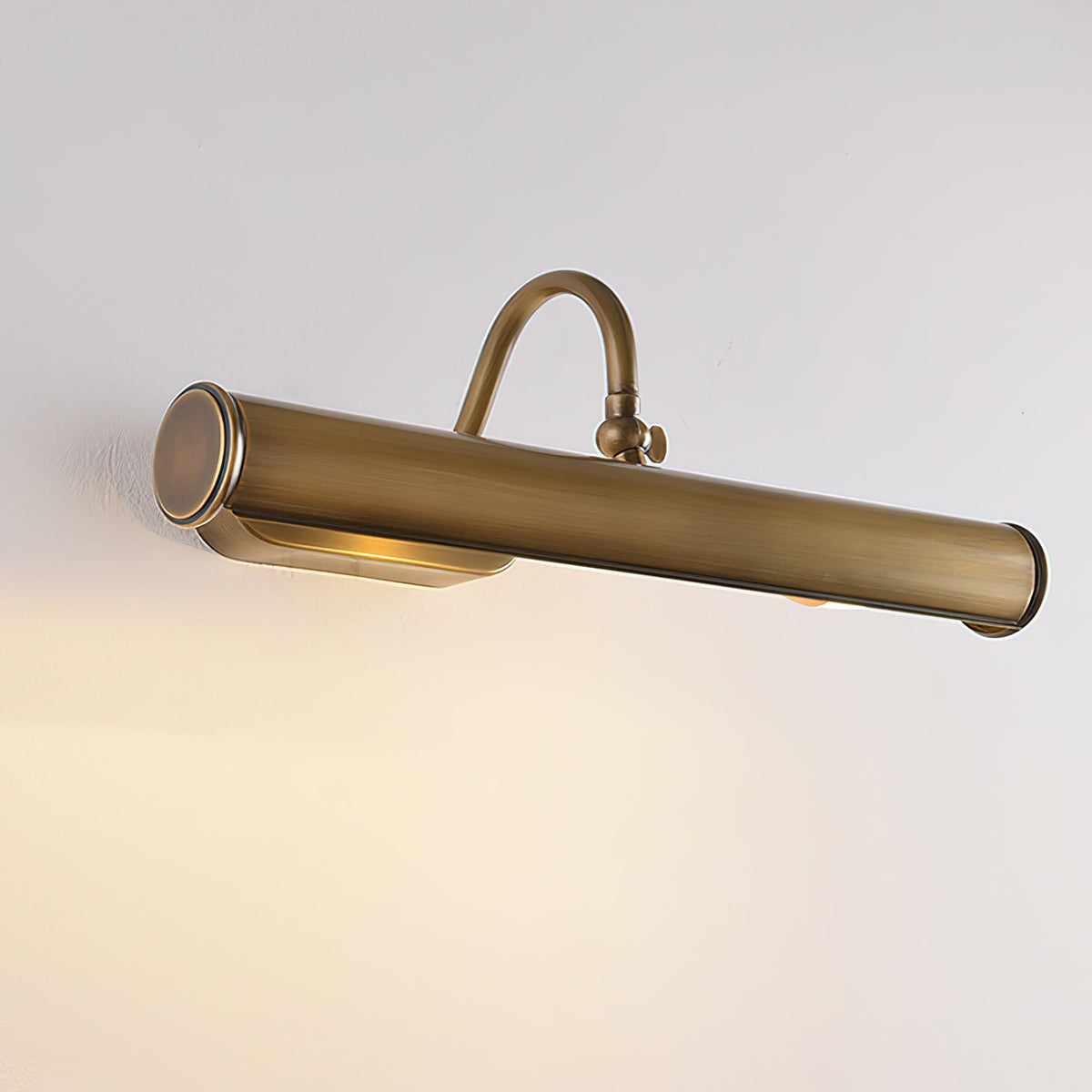 The Ainsworth Wall Sconce lighting a bookshelf in a study.
