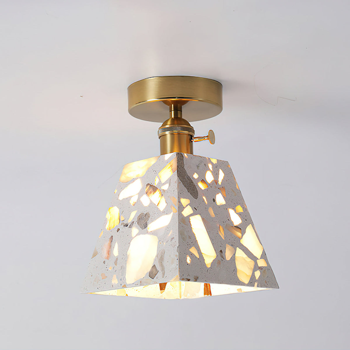 Close-up of the Alvaro Ceiling Lamp's translucent stone shade with amber fragments.