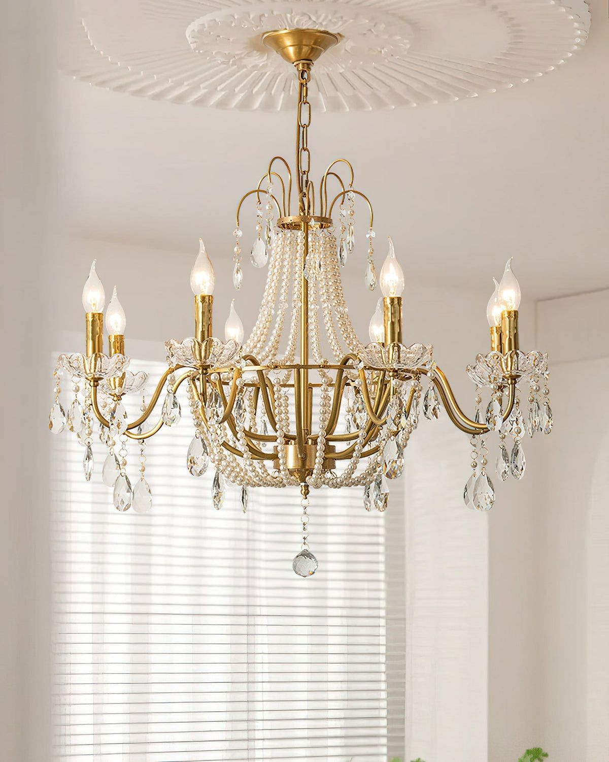 Arcadia Crystal Chandelier illuminated in a luxurious living room.