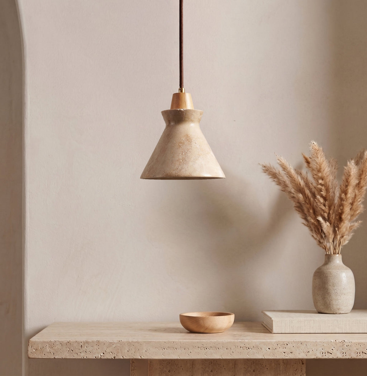 Lifestyle image of the Athena pendant in a modern living room corner.