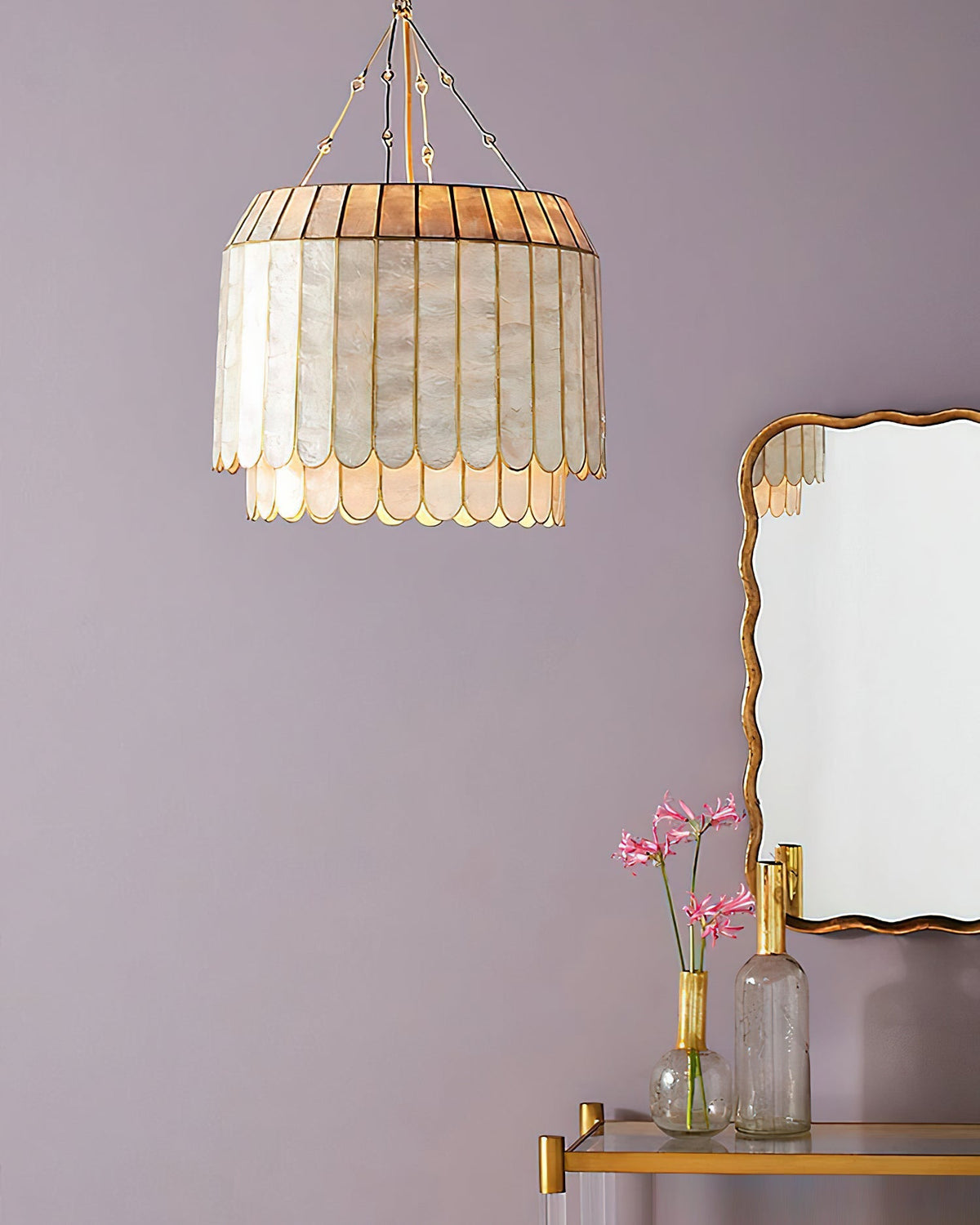 The Aurelia Capiz Pendant Lamp illuminated, casting a warm, iridescent glow.