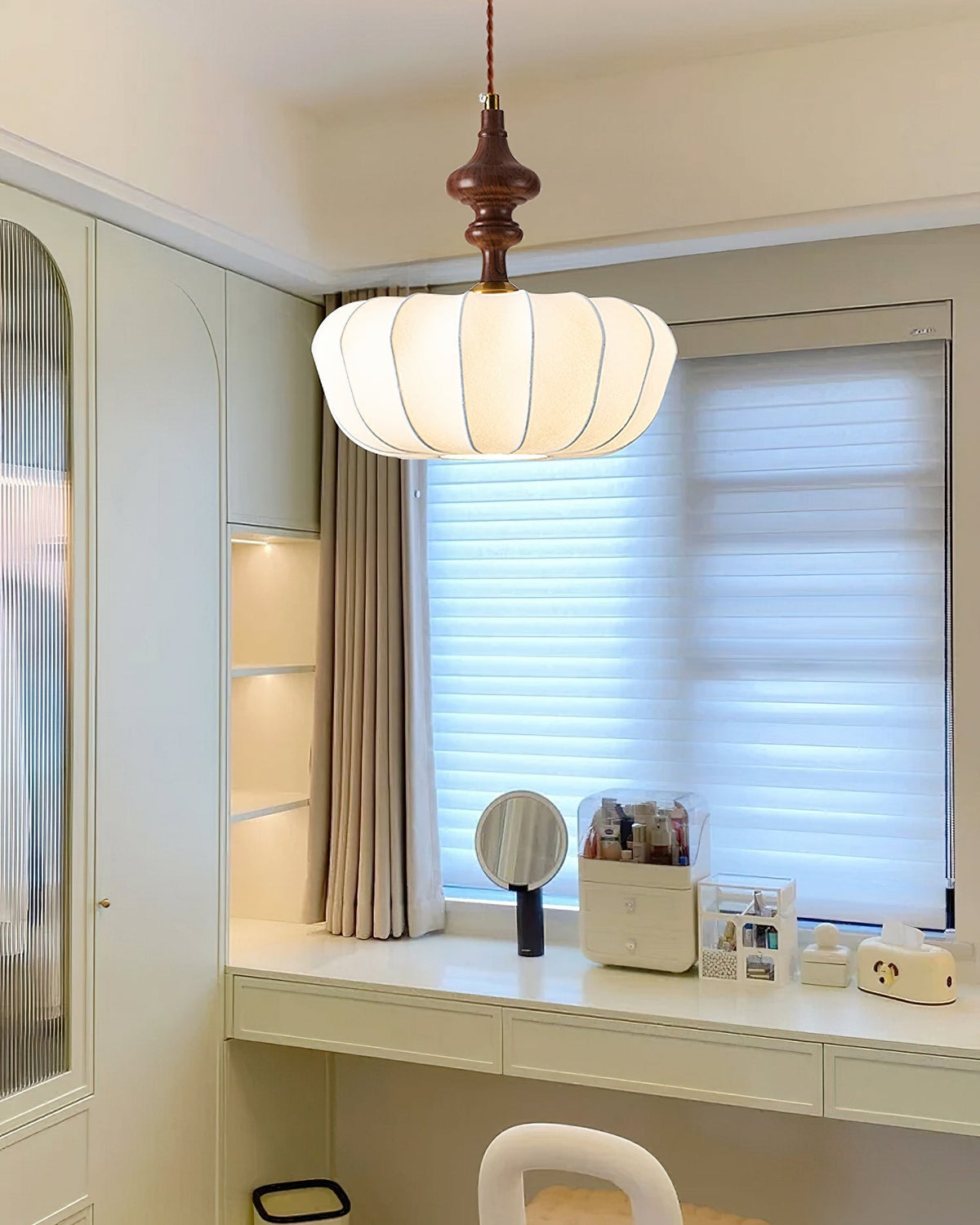 Lifestyle image of the Baird Pendant Light in a cozy living room corner.