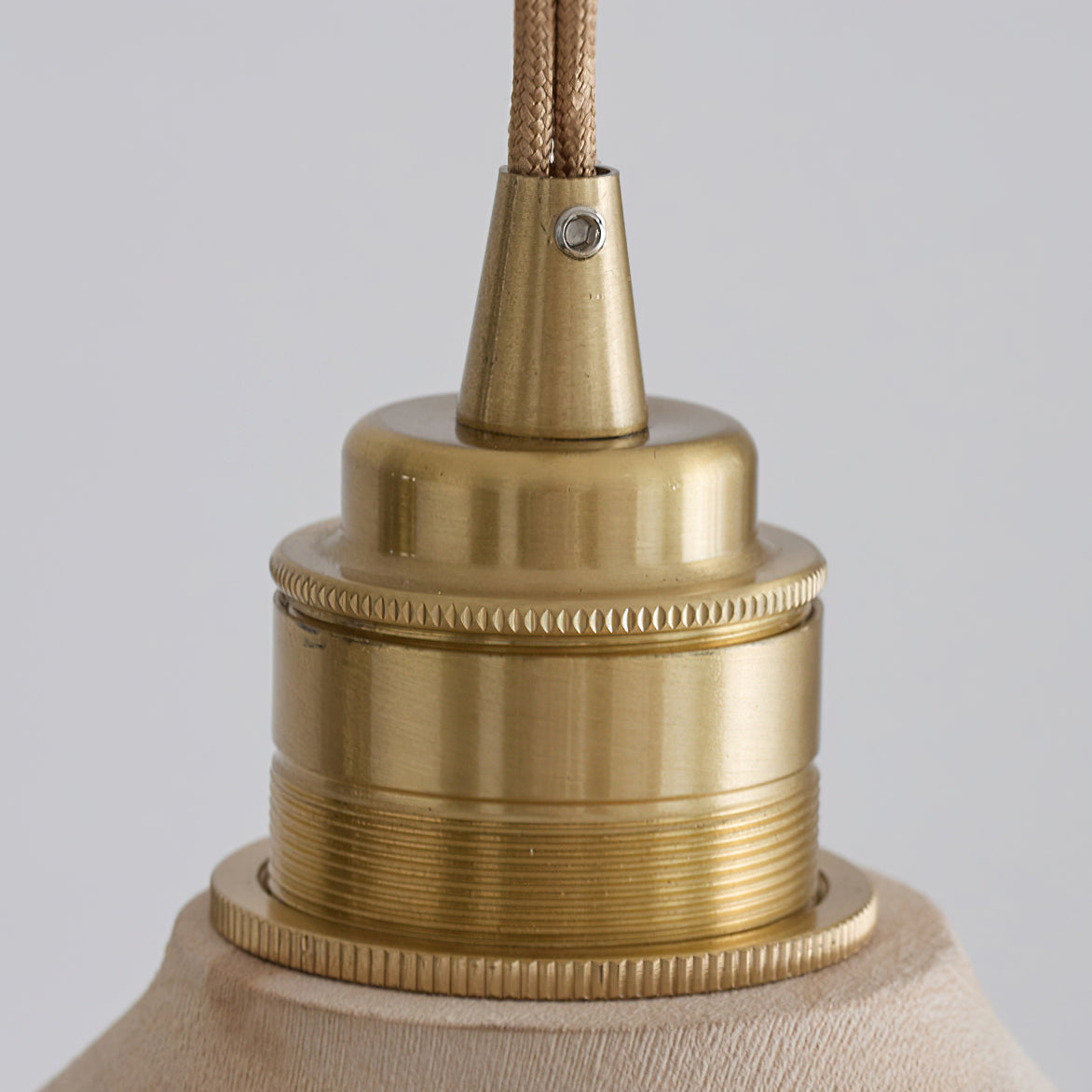 The natural wood texture of the Baxter Pendant Light's shade.