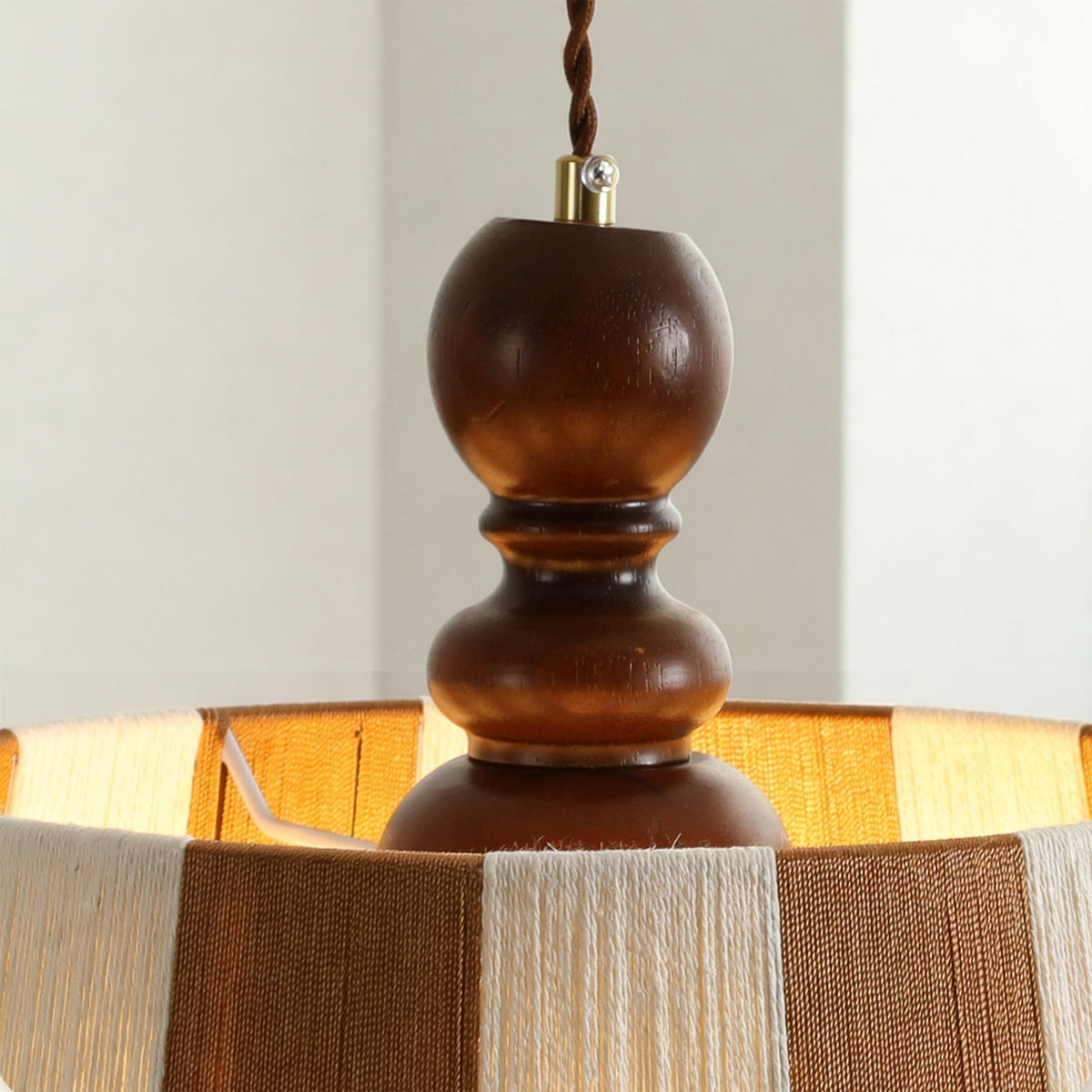 Detail of the wooden accent and metal hardware of the Beatrice Pendant Light.