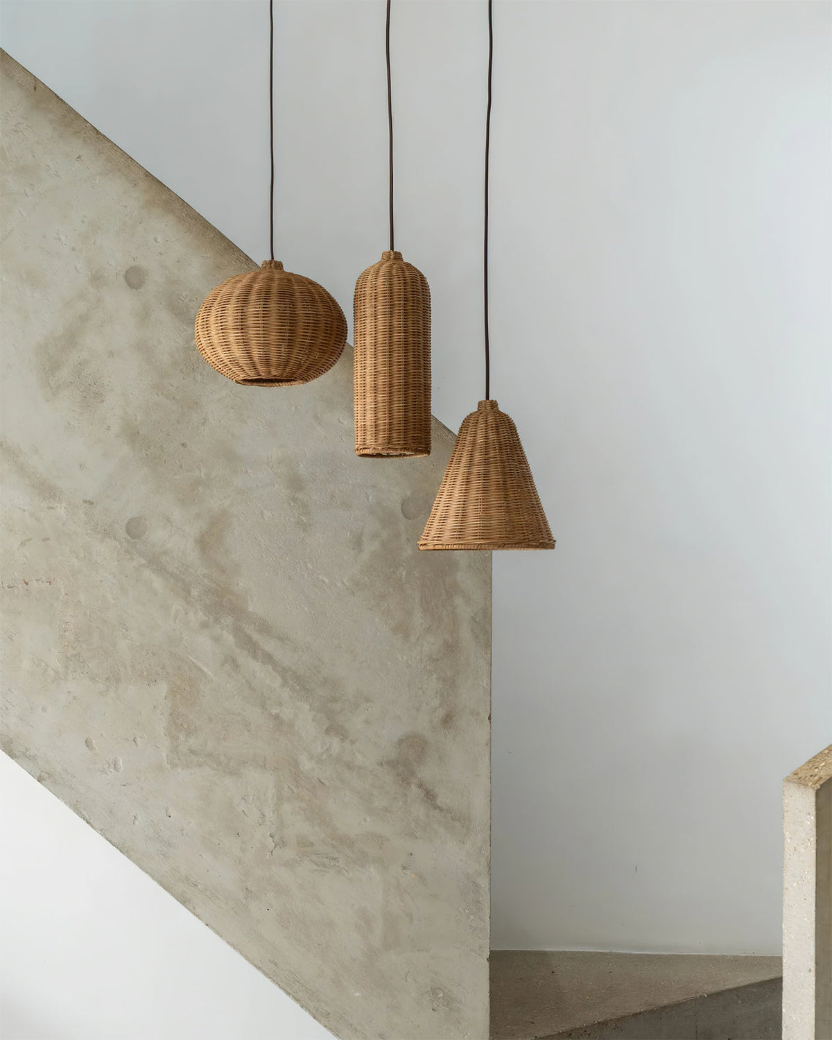 A single Beliani rattan pendant light hanging over a kitchen counter.