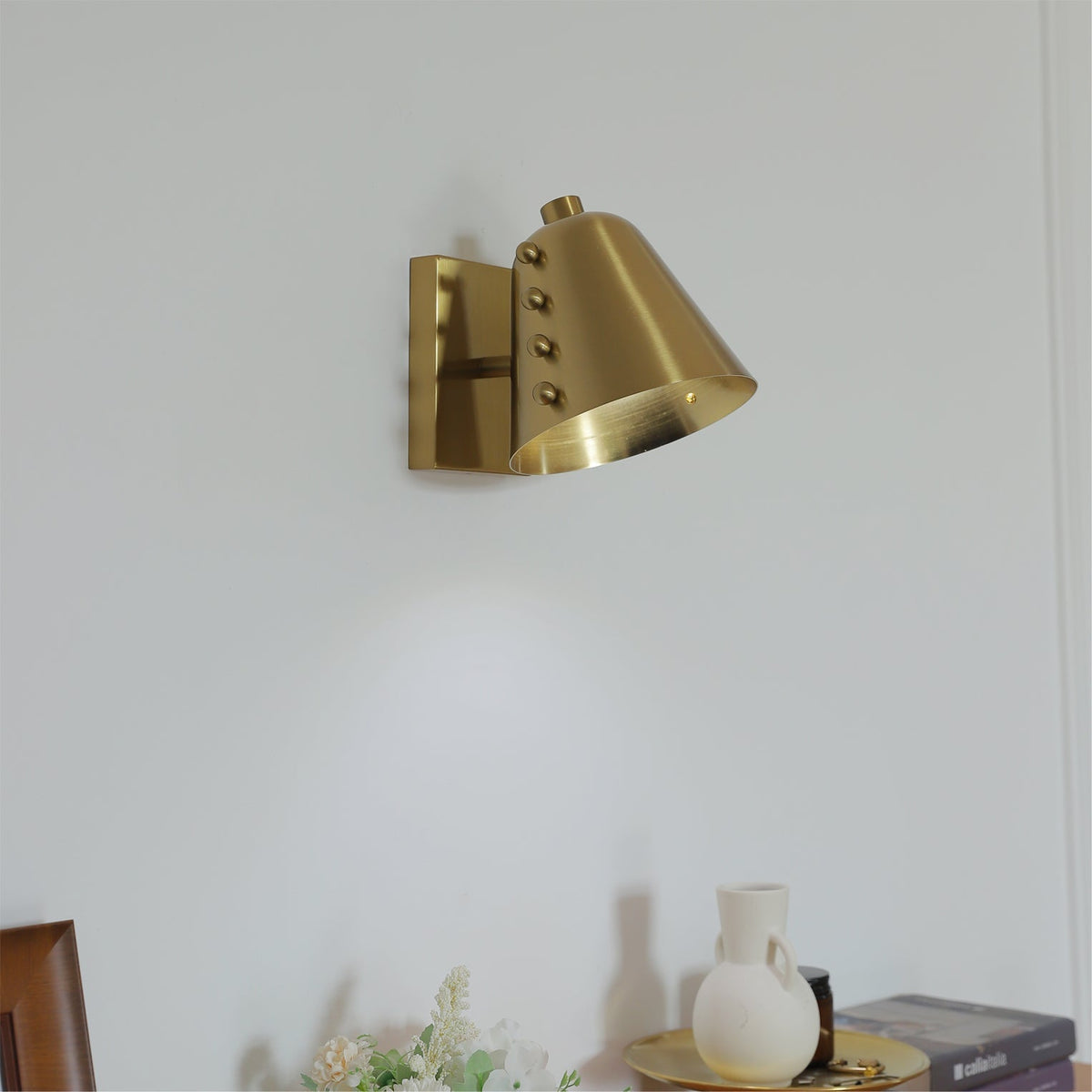 Close-up of the Bespoke wall lamp's metallic finish.