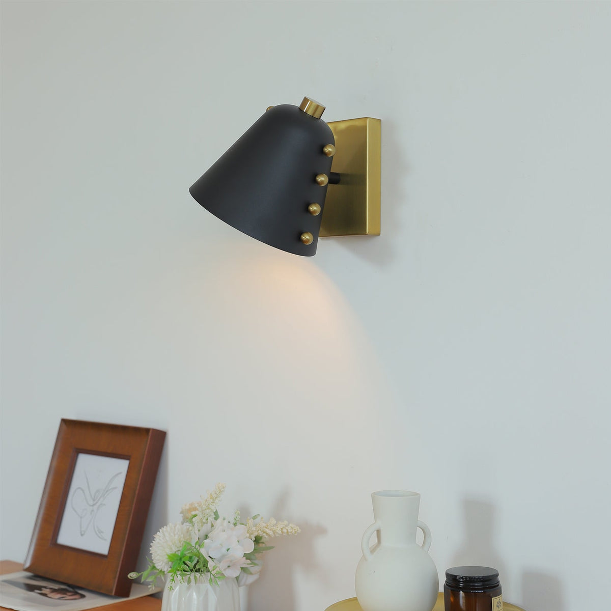 Bespoke geometric wall lamp in black finish against a light wall.