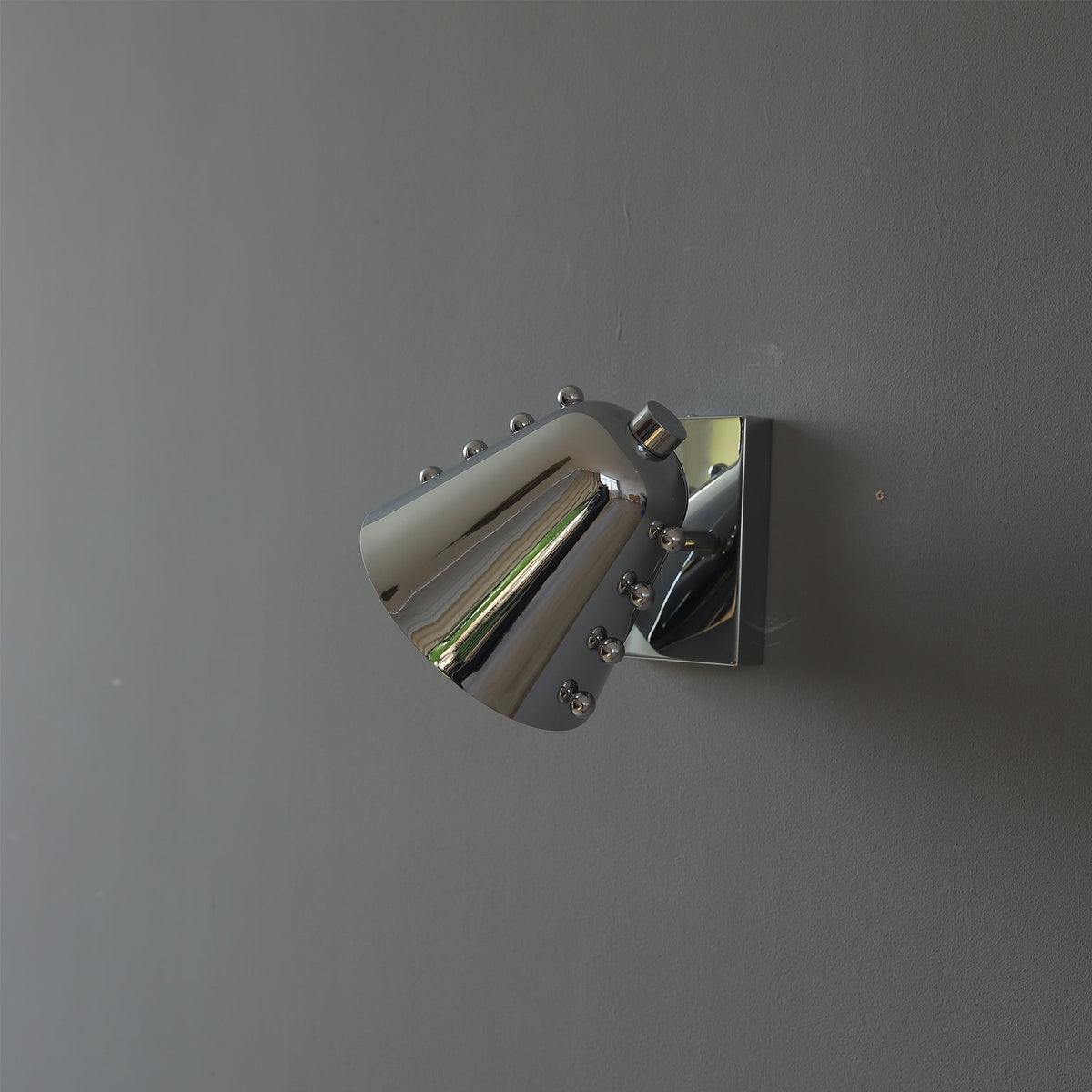 Bespoke wall lamp in a gold finish, unlit.