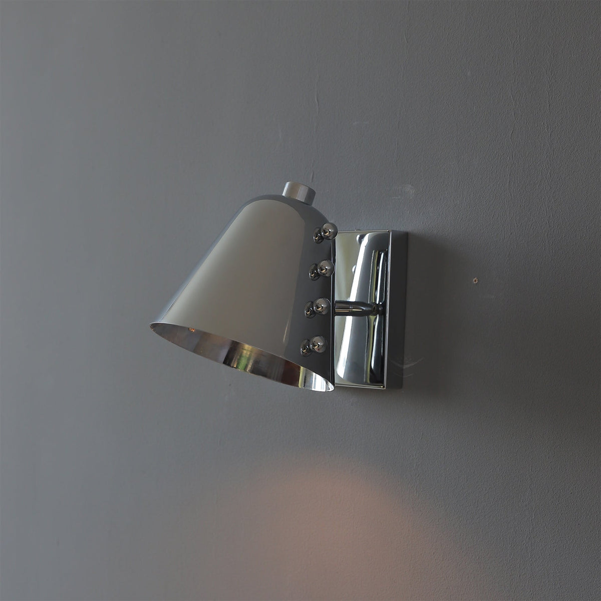 Bespoke wall lamp in a chrome finish, unlit.