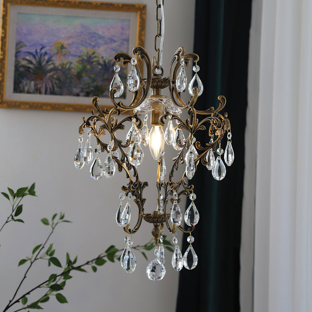 The pendant light hanging from its chain against a dark wall.