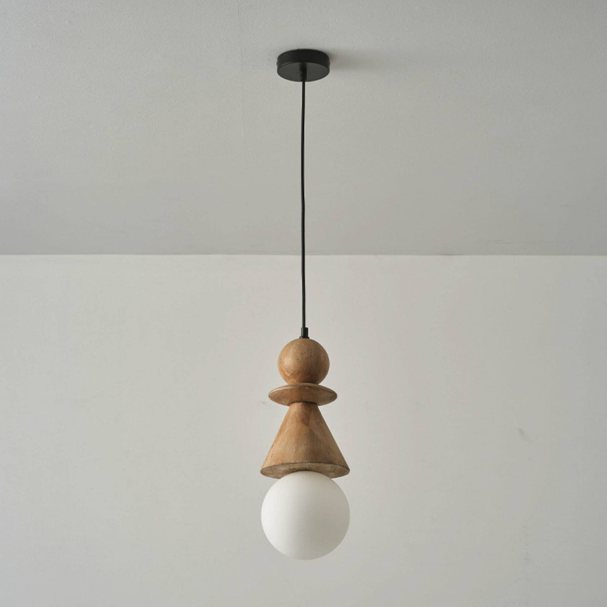 The Bodie stacked wood totem pendant light in a black finish.