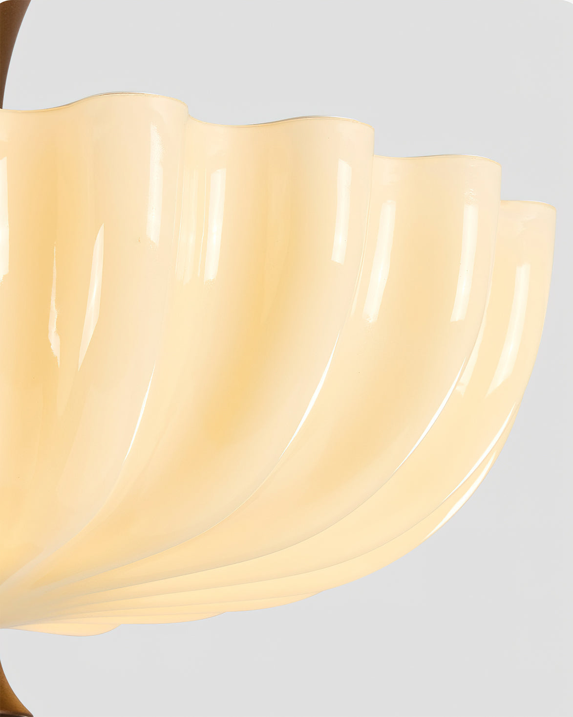The lamp hanging above a minimalist wooden table.