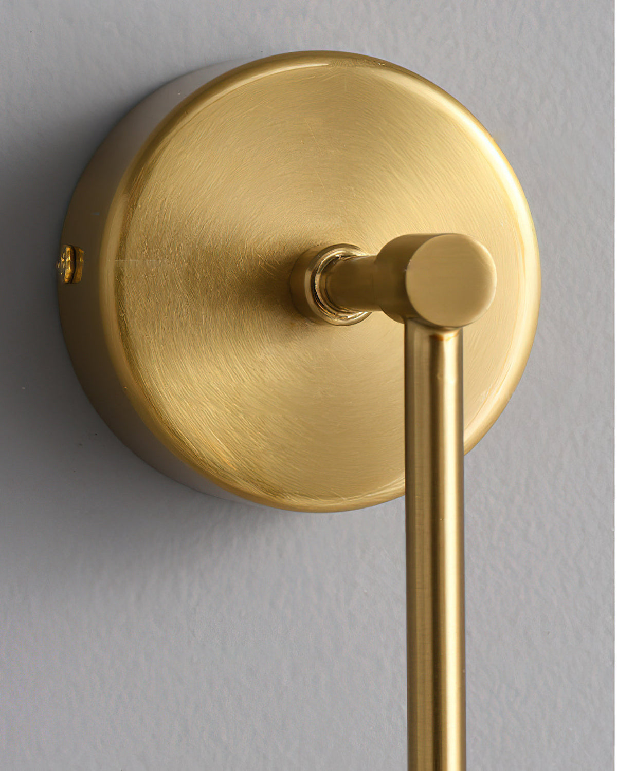 The Brace Alabaster Wall Lamp with the gold finish option.