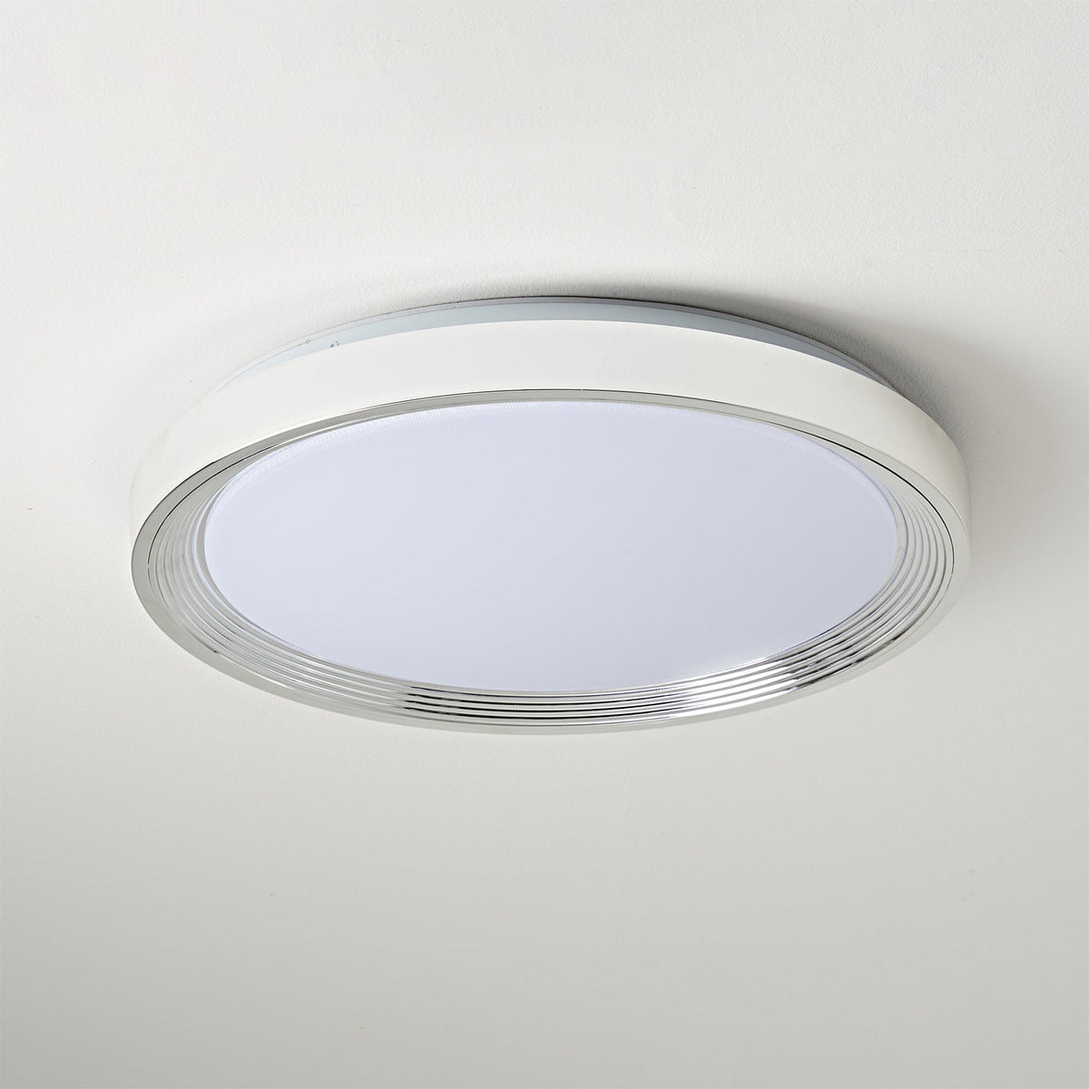 The light fixture casting an even illumination in a dark room.
