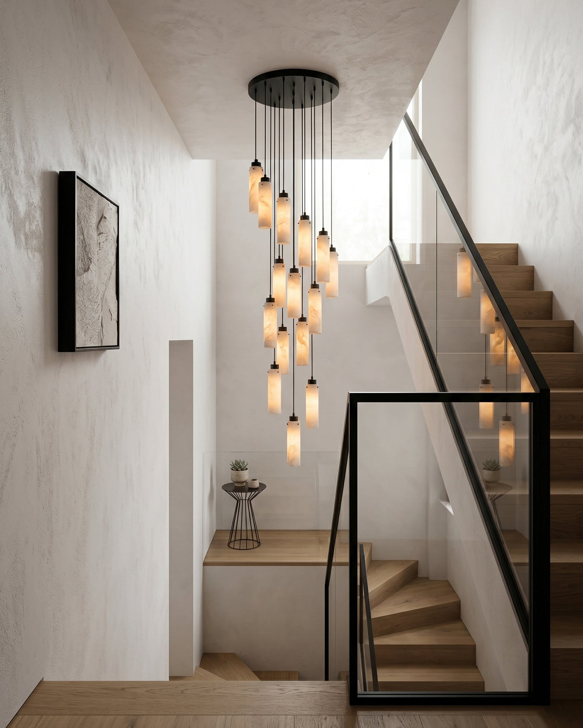 The alabaster chandelier hanging in a grand two-story foyer.