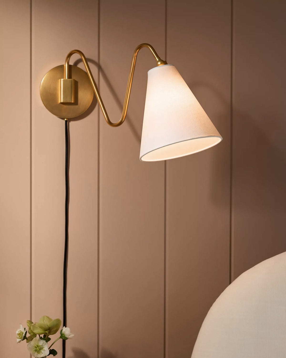 Detail shot of the brass finish and wall mounting plate.