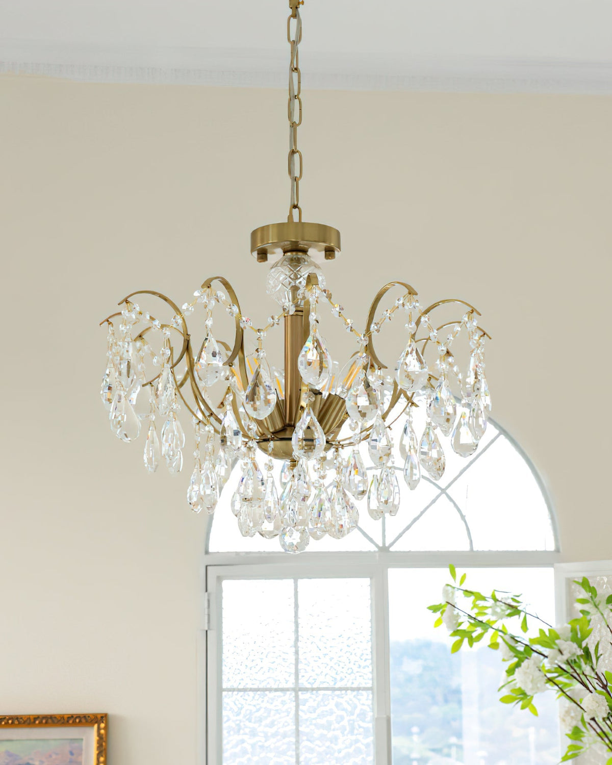 The Colette Chandelier in a living room with high ceilings.