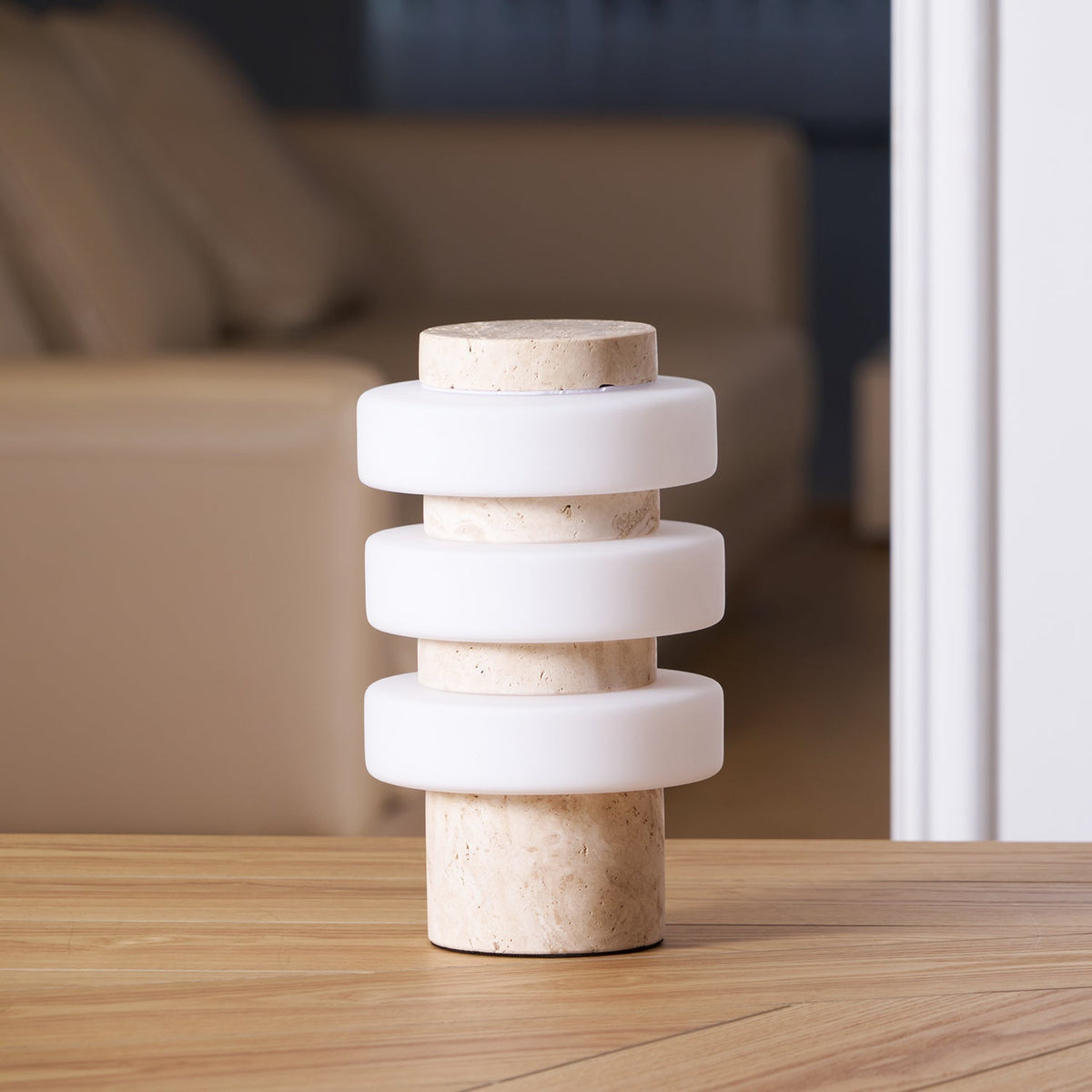 Corba Table Lamp in beige marble against a neutral background.