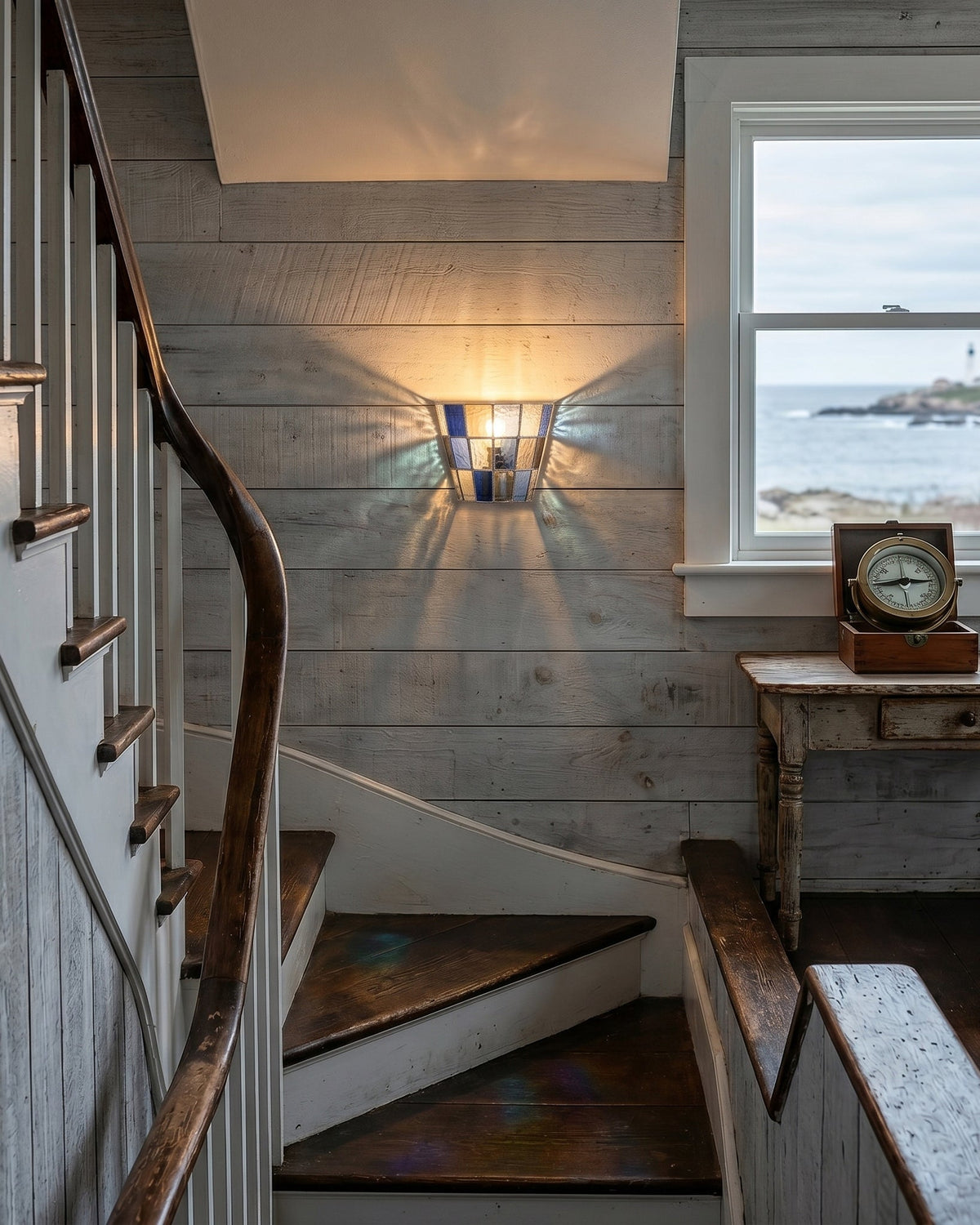 Angled shot of the blue glass Zola Sconce.