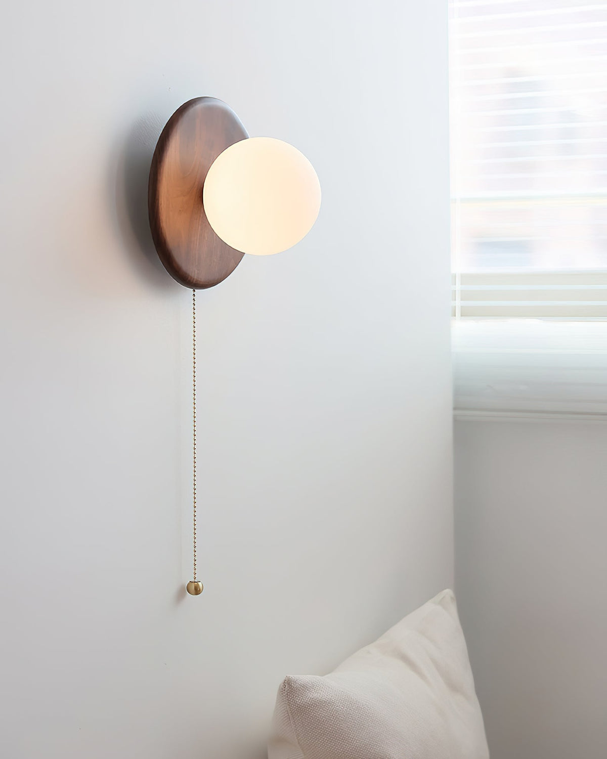 The Abel wood disk light illuminated, casting a warm glow.