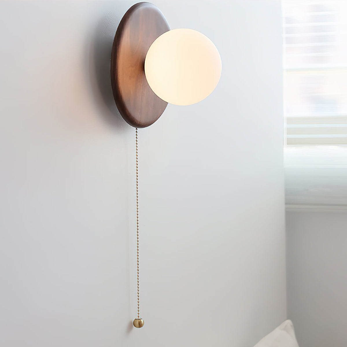 Detailed view of the wood grain and metal accents on the light fixture.