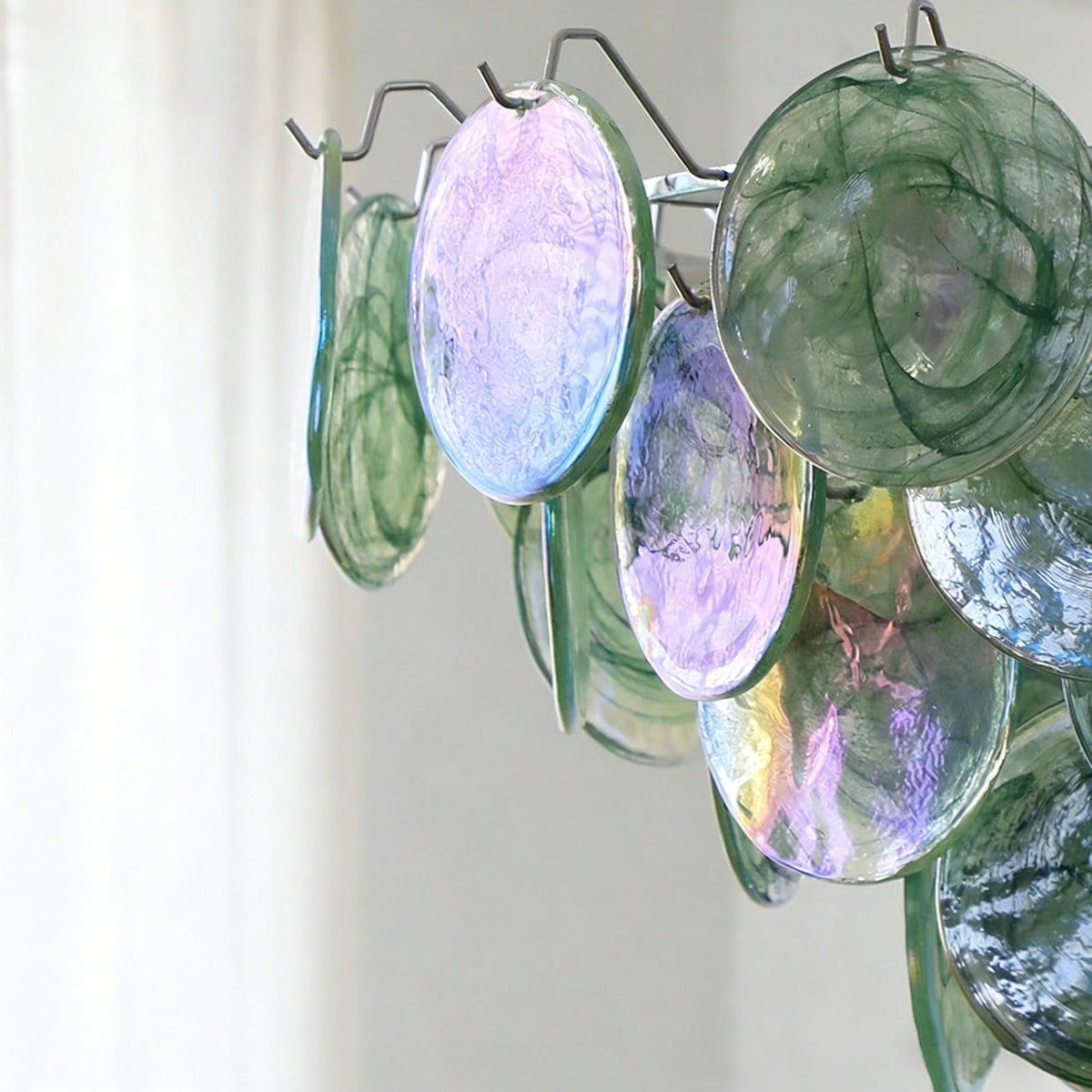 Angled view of the Brette Disk Glass Chandelier, highlighting light refraction.