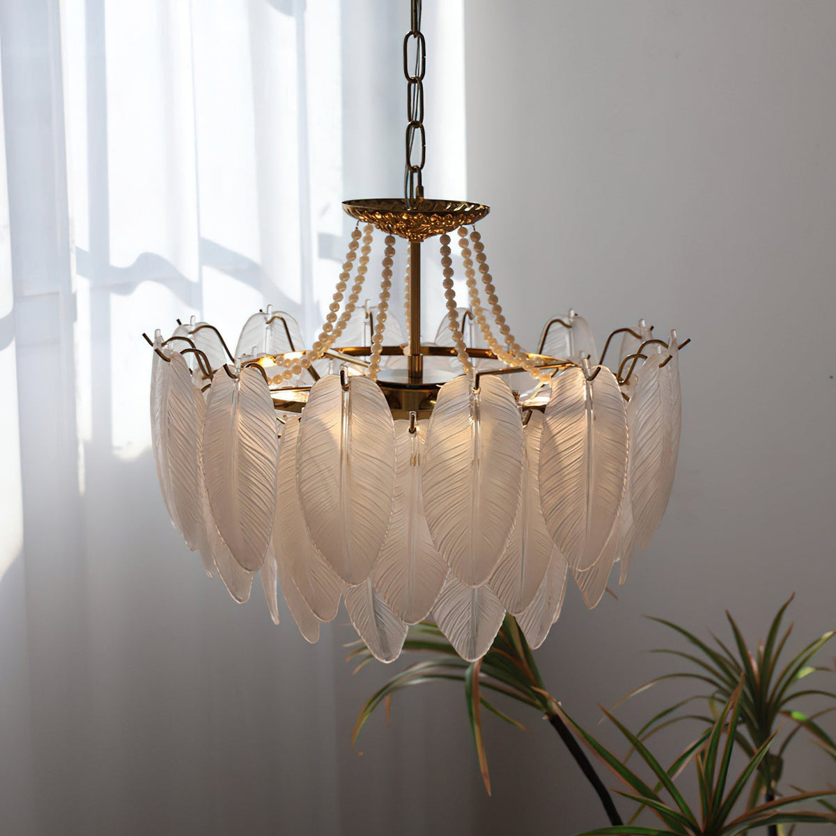 The Antheia Chandelier illuminated, casting a warm and ethereal glow.