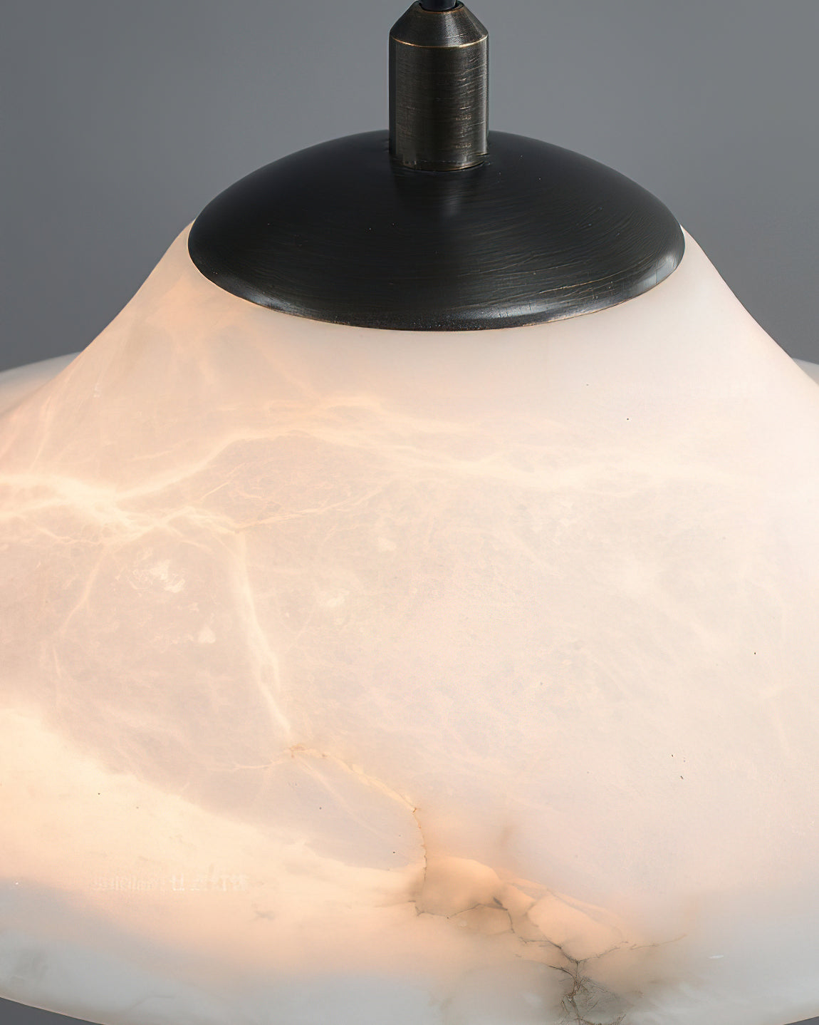 The pendant light shown against a dark background to highlight its form.