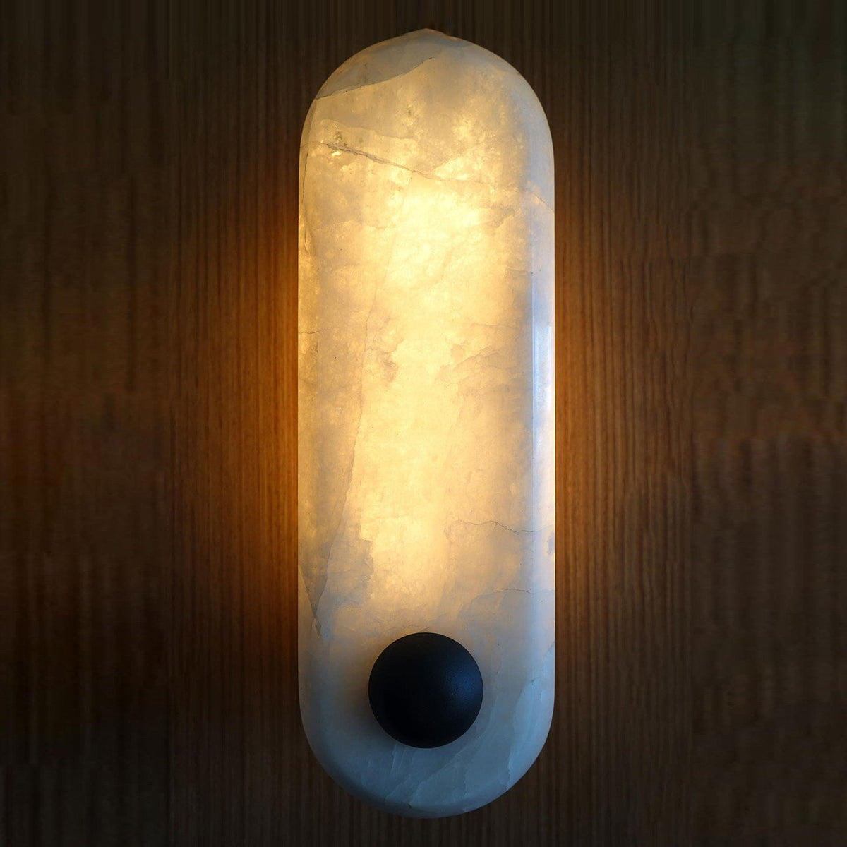 Lifestyle image featuring the Breuer Alabaster Wall Sconce in a stylish hallway.