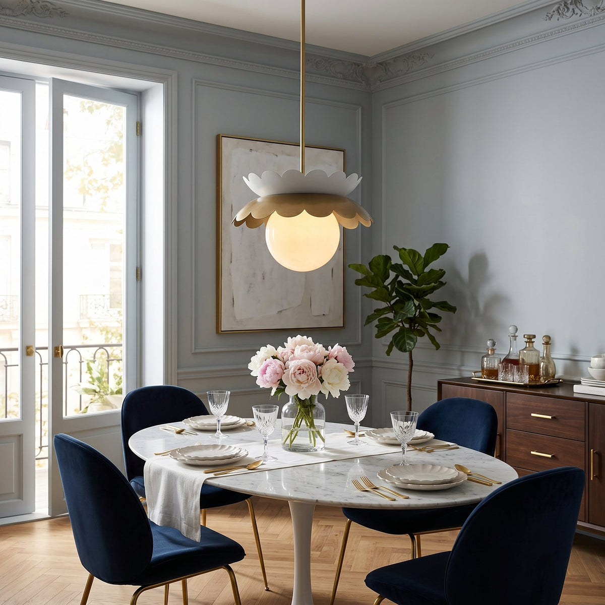 Close-up of the Capri Globe Pendant Light's glass shade and gold hardware.