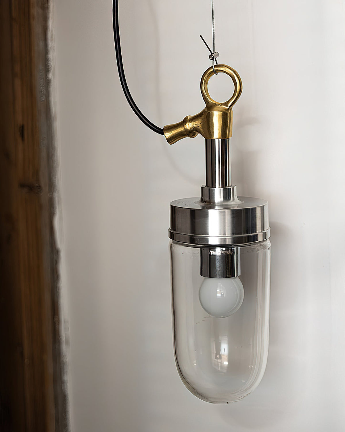 Detail of the chrome metal fixture and mounting of the pendant light.