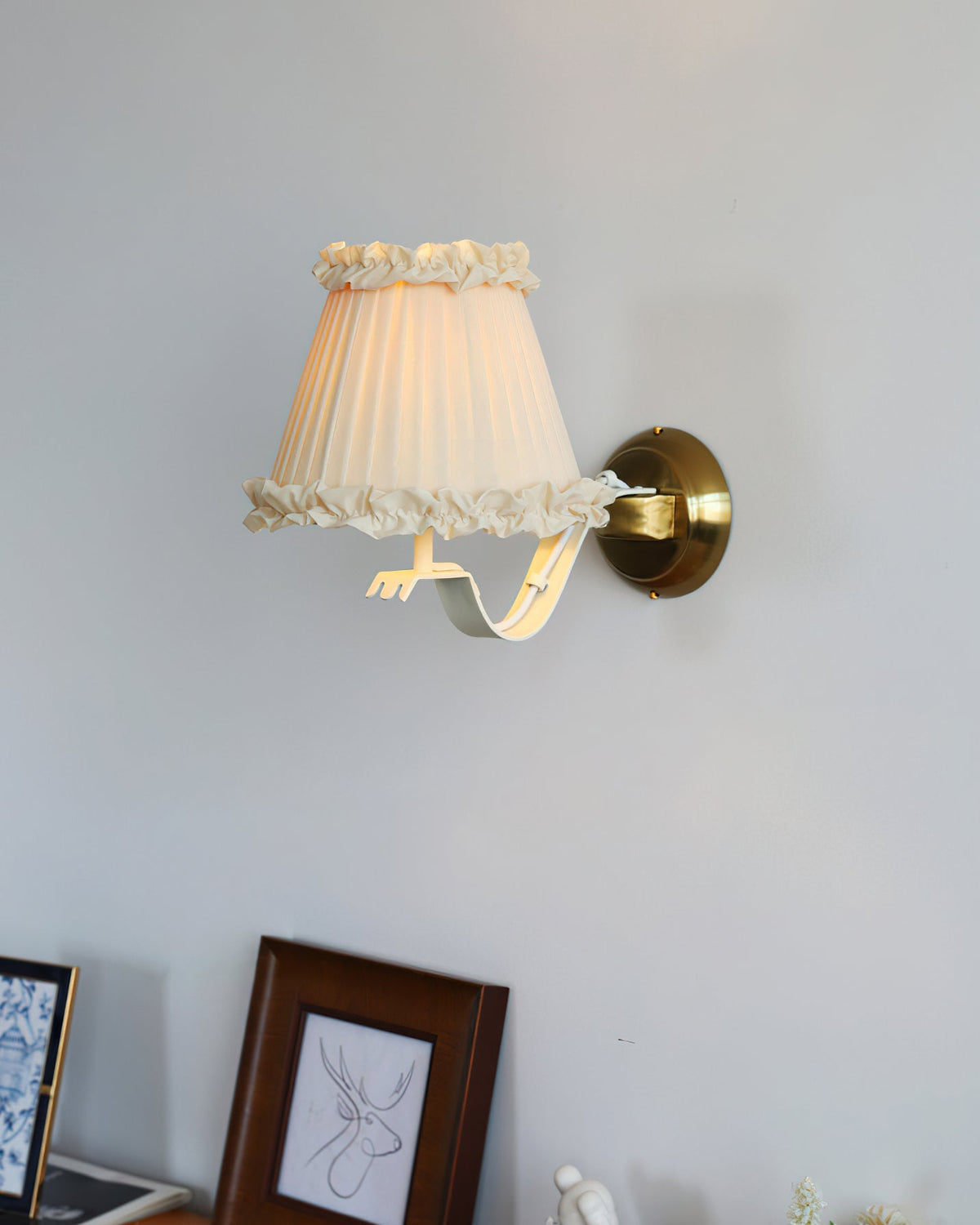 A pair of Chantal Ruffle Wall Sconces flanking a vanity mirror.
