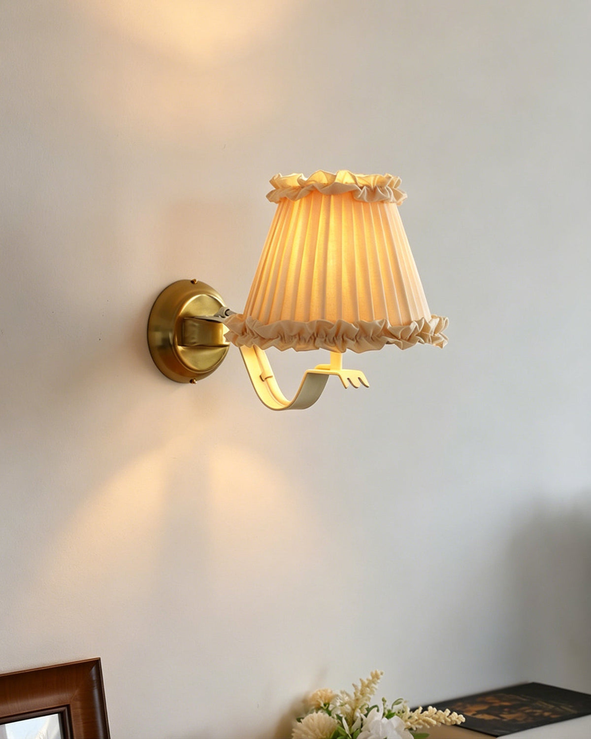 Angled view of the Chantal wall light, highlighting its ruffled shade.