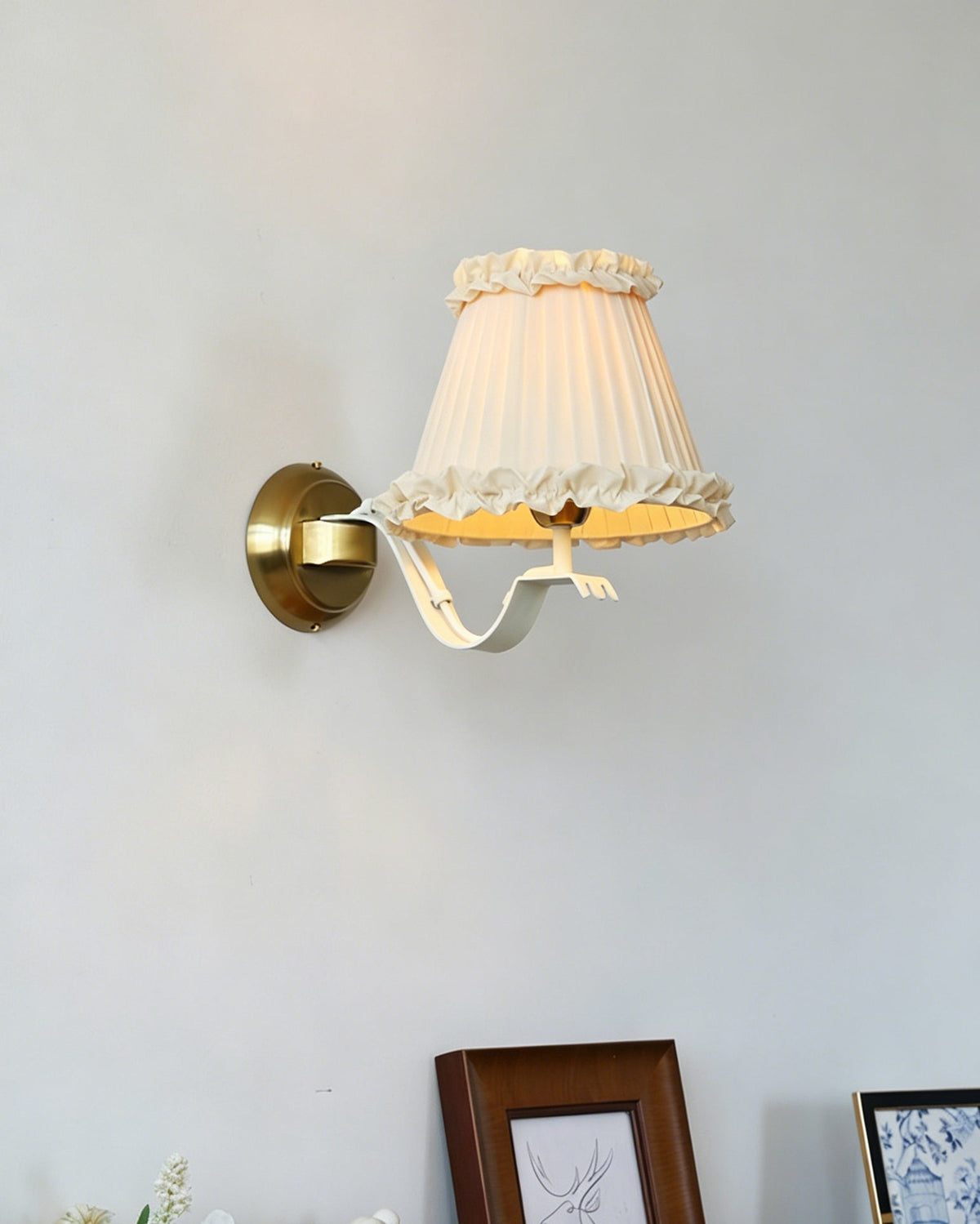 The wall sconce shown unlit, displaying its form and texture.