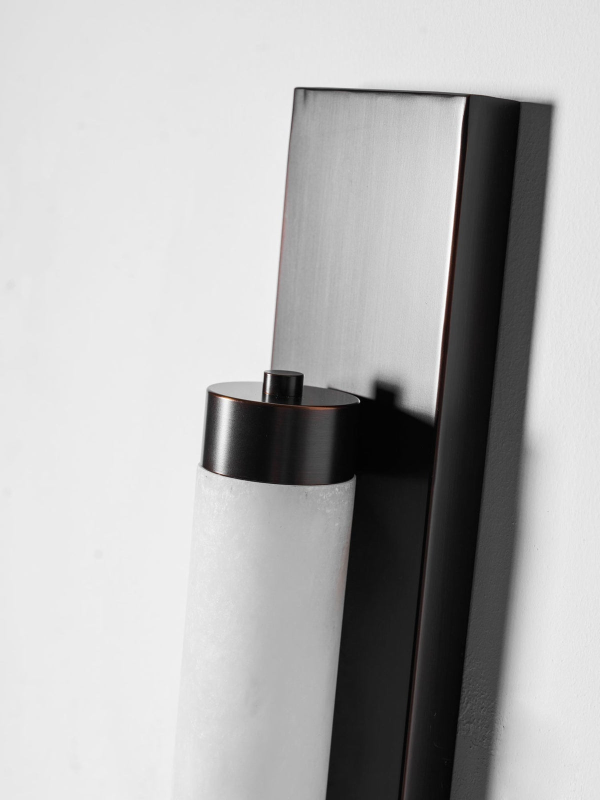 The Columnar Alabaster Wall Lamp with bronze finish.