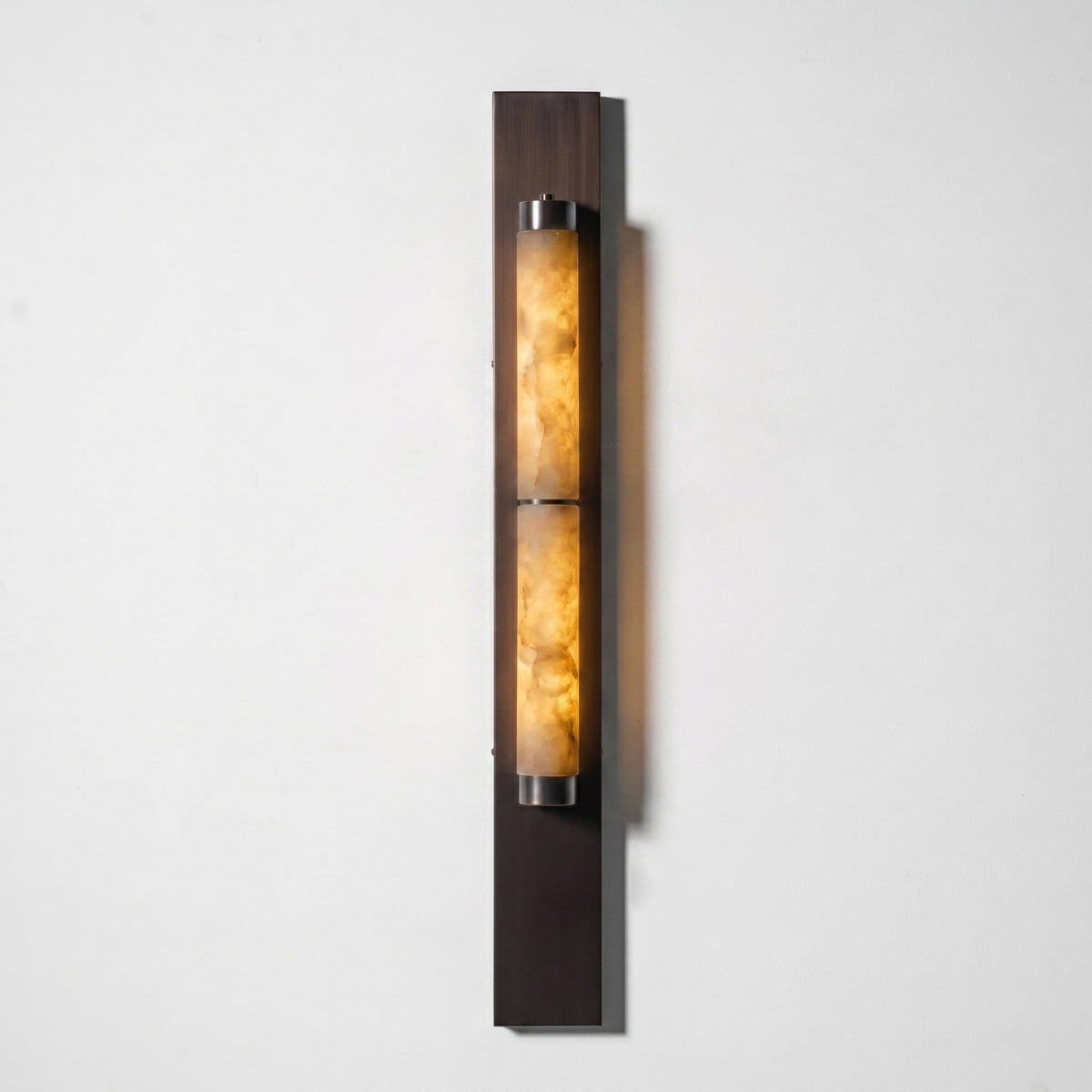 The Columnar Alabaster Wall Lamp in a minimalist interior design.
