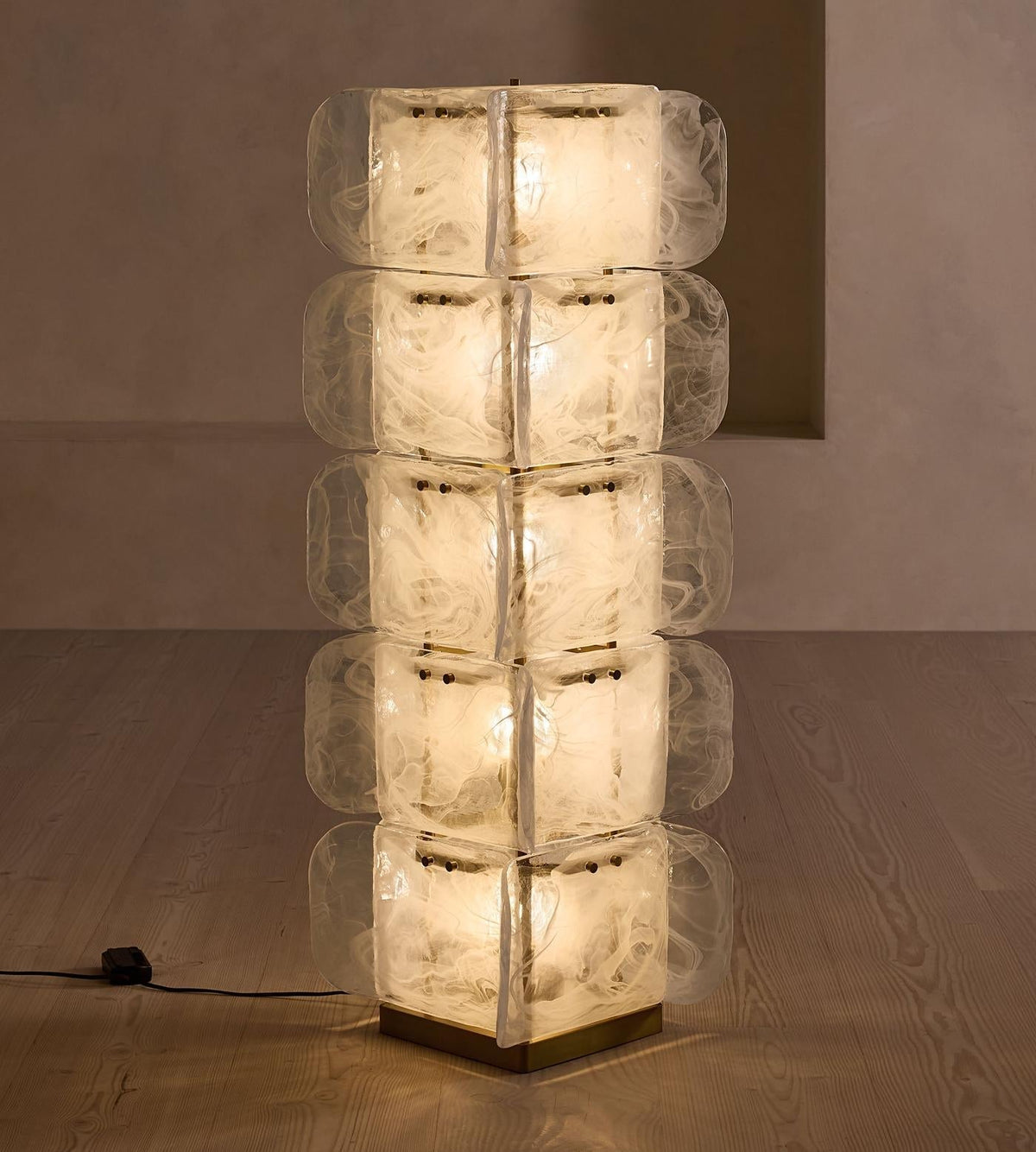Scale of the 140 cm tall Cubo Totem Floor Lamp next to a sofa.