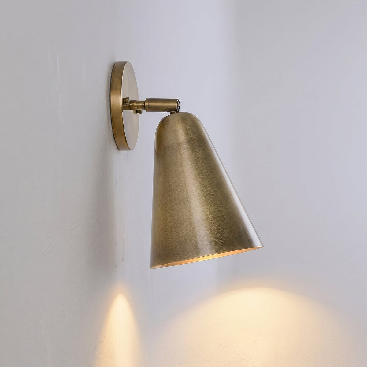 Donna Swivel Sconce in brass finish, tilted upwards.