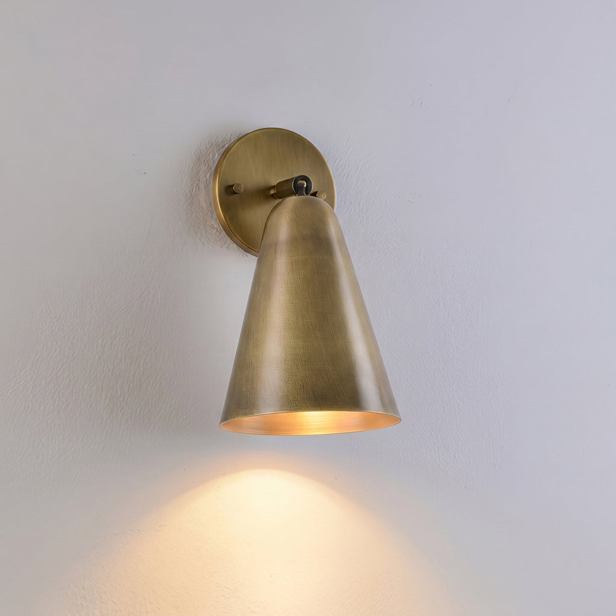 Donna Swivel Sconce in black finish against a white wall.