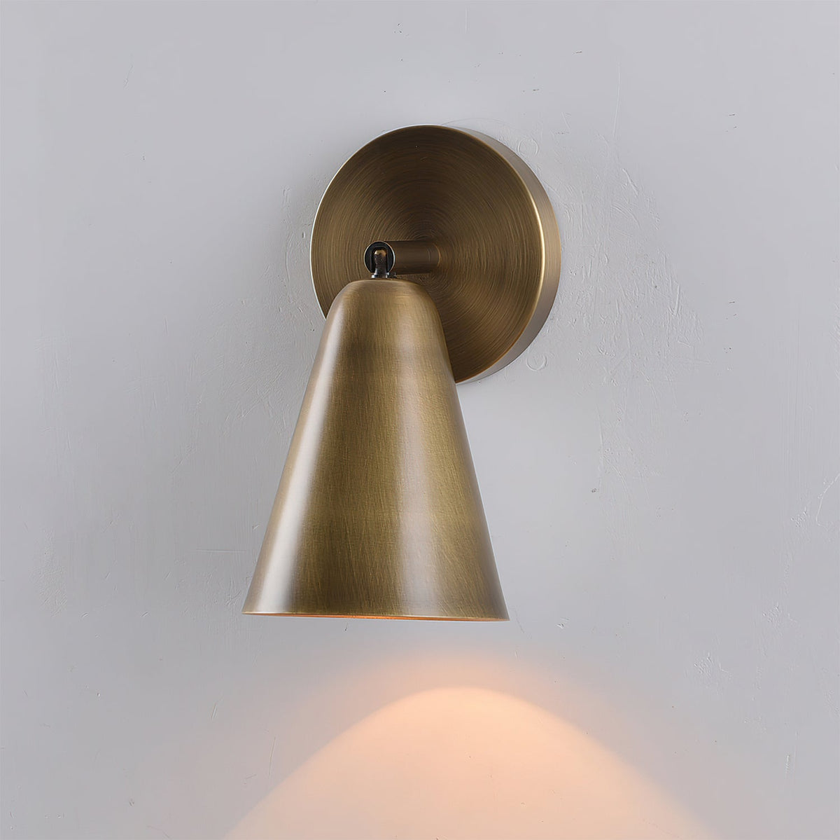 Close-up on the wall mounting plate of the sconce.