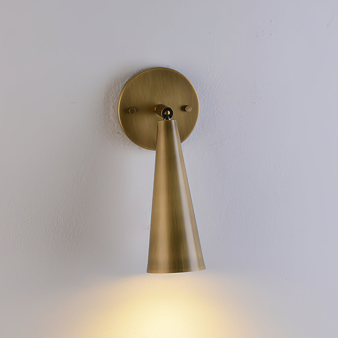 Angled view of the brass sconce.