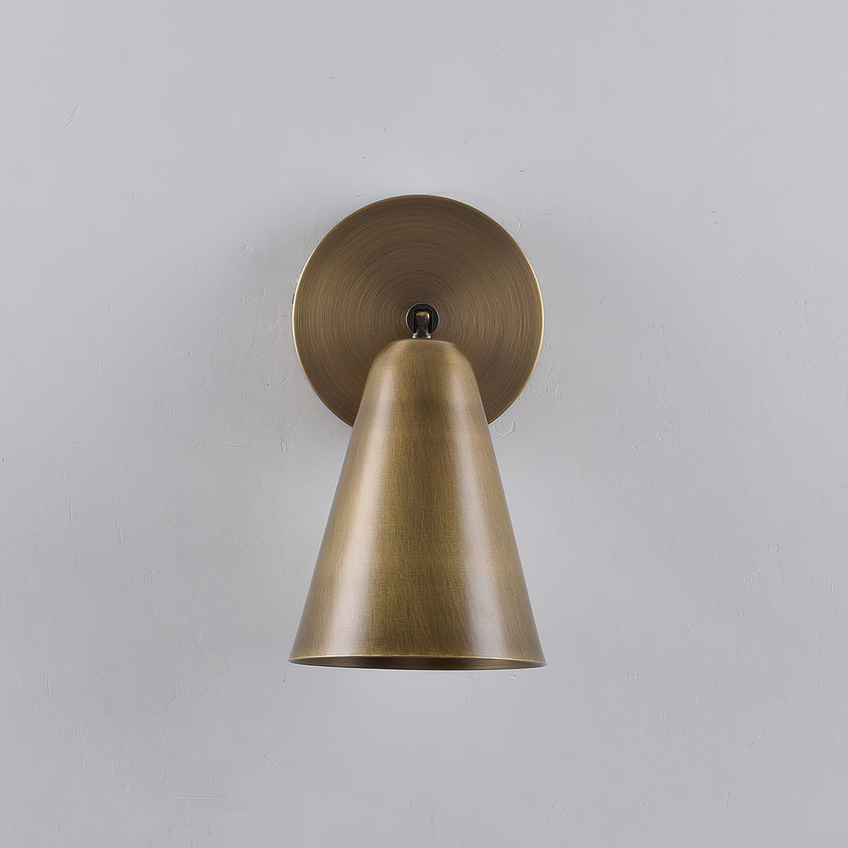 Lifestyle shot of the sconce installed over a nightstand.