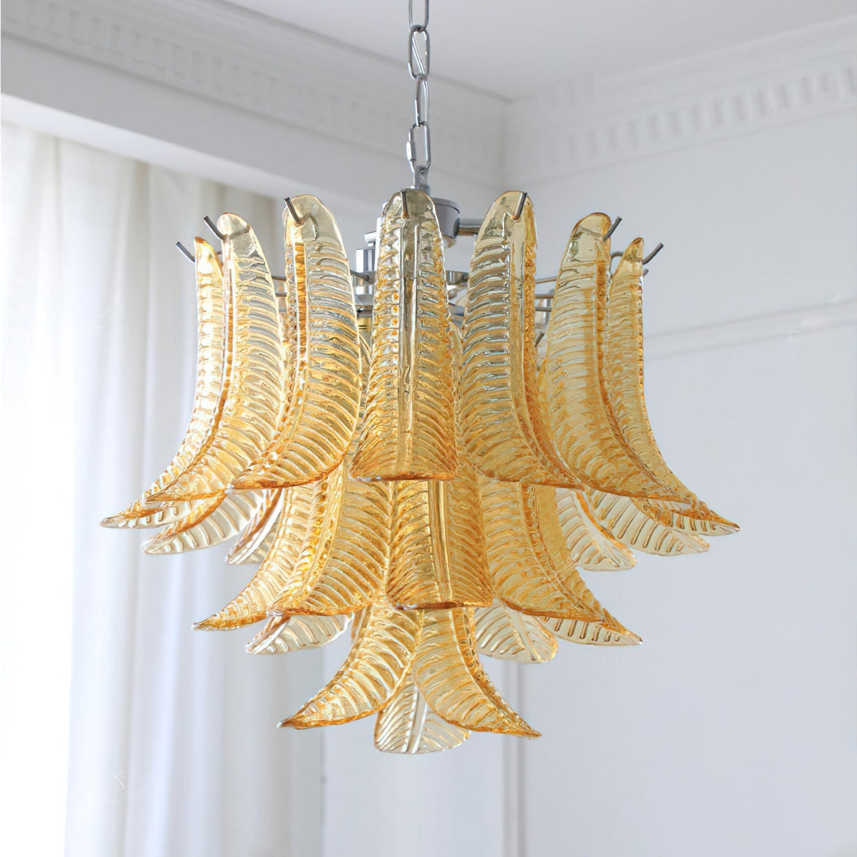 The chandelier turned off, highlighting the glass texture.