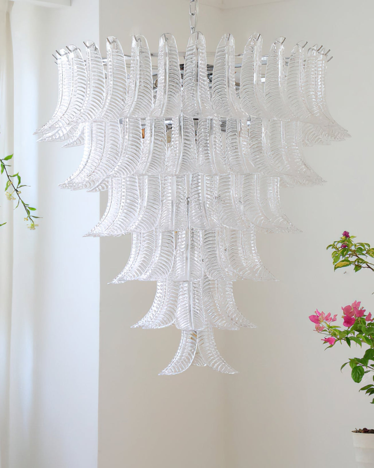 The Eclissi Chandelier illuminating a dining table.
