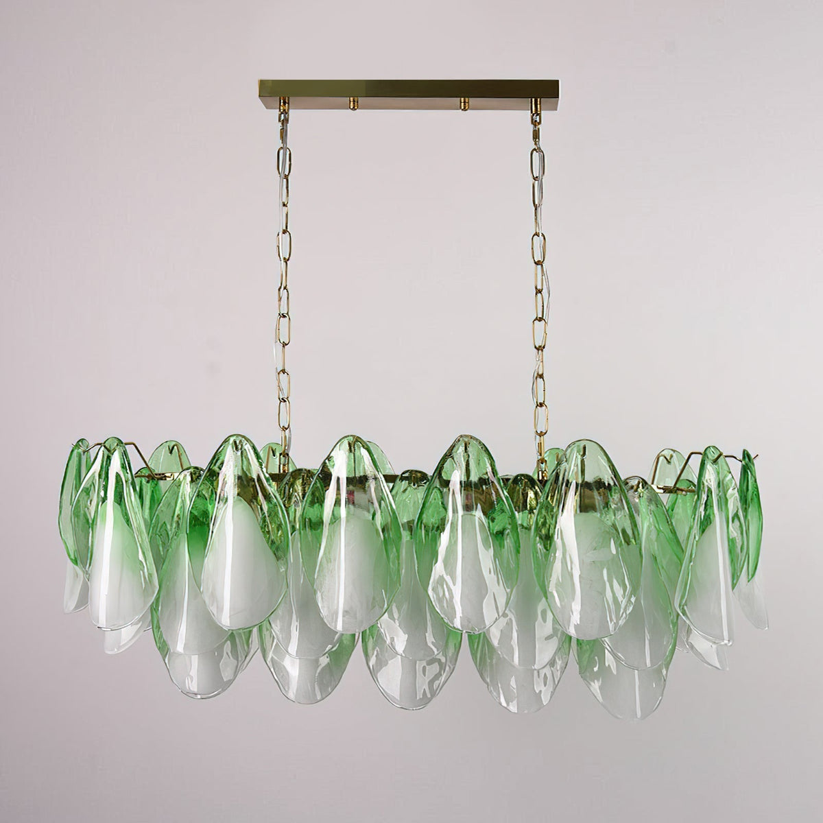 The Flora linear chandelier hanging above a modern dining table.